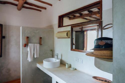 a bathroom with a sink and a mirror at Hekaya Zanzibar in Pingwe
