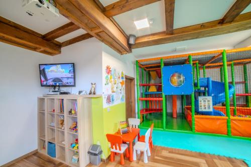 a room with a table and chairs and a play room at Pensjonat Sekuła*** in Bukowina Tatrzańska
