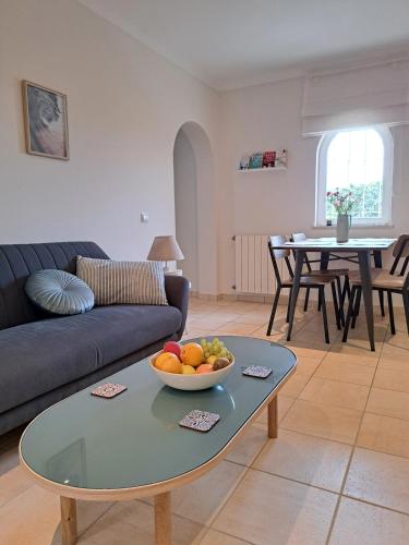 a living room with a couch and a bowl of fruit on a table at Casa Canavial in Luz