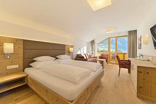 a bedroom with a large bed in a room at Hotel Kristall in Grossarl
