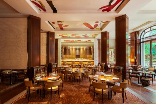 a restaurant with tables and chairs in a room at Hôtel Le Royal Monceau Raffles Paris in Paris