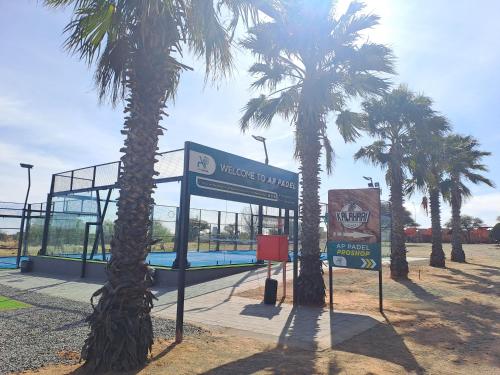 a gas station with palm trees in front of it at Kalahari Lodge Kimberley in Kimberley