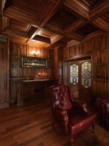 a living room with a chair and a desk at The Castle - Your unique way of retreat in Borovets