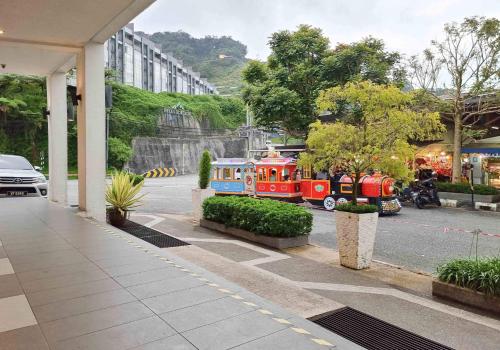 a toy train on a street next to a building at Mossy Forest Family Retreat II, 2-8 pax, Cameron Highlands in Cameron Highlands
