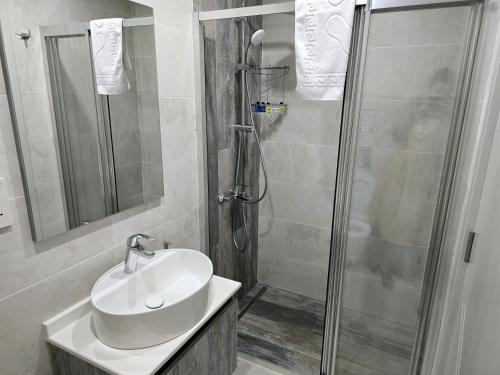 a bathroom with a sink and a shower at Nurel Shark Residence in Kérynia