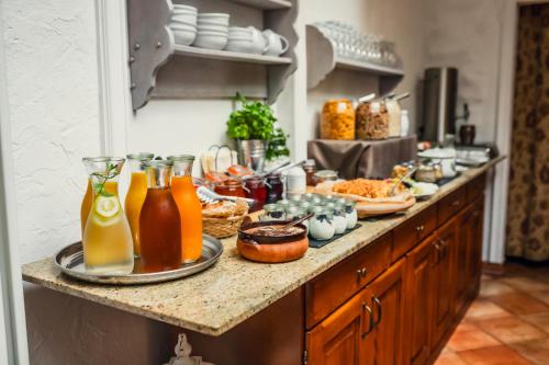 a kitchen counter with food and drinks on it at Hotel Italia in Görlitz