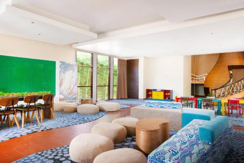 a living room with chairs and a green screen at The Westin Resort Nusa Dua, Bali in Nusa Dua