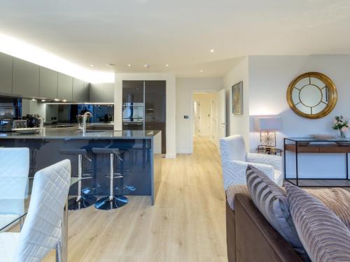 a large kitchen and living room with a blue counter top at 2 Bed Property Close to Heathrow Airport in Hounslow