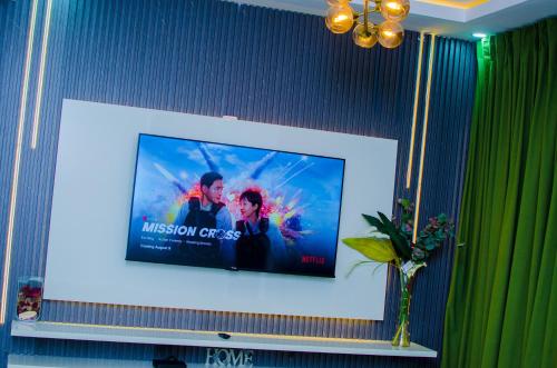 a flat screen tv sitting on a wall at Tranquil Old Bodija Retreat - 3 Bedroom House in Ibadan