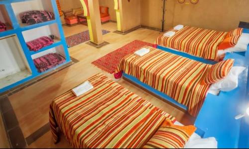Postel nebo postele na pokoji v ubytování Hotel le Touareg