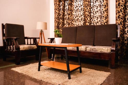 a living room with a couch and a table at Akim Homestay in Kohīma