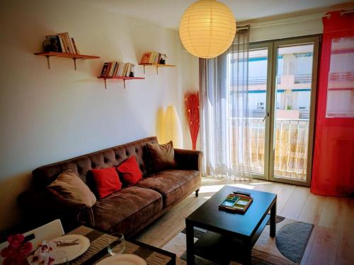 un salon avec un canapé et une table dans l'établissement Joli appartement proche Genève, à Annemasse