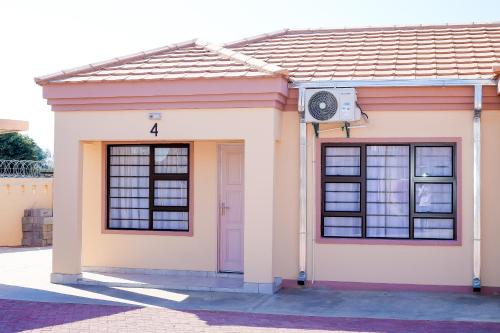 a small house with a door and a speaker at JTown CBD Self-Catering Apartment in Jwaneng