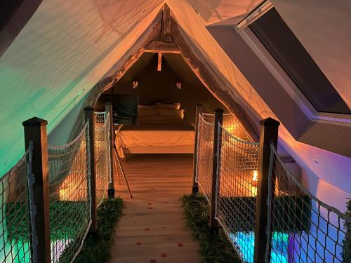 a room with a tent with a bed in it at L'Écrin d'Azurite in Saint-Clair-sur-les-Monts
