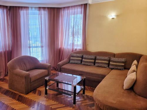 a living room with a couch and a table at Home Hotel Apartments on Kontraktova Ploshcha in Kyiv