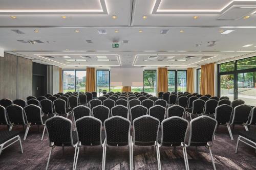 a room with rows of chairs in a room with windows at Stay inn Hotel Warszawa in Warsaw