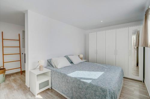 a white bedroom with a bed and a white cabinet at Villa Panorama Chayofa in Chayofa