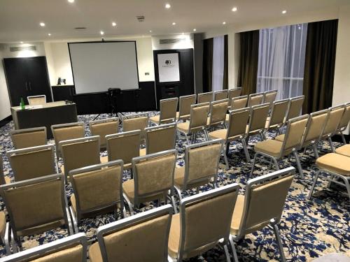 a conference room with chairs and a whiteboard at DoubleTree by Hilton Hotel Nottingham - Gateway in Nottingham