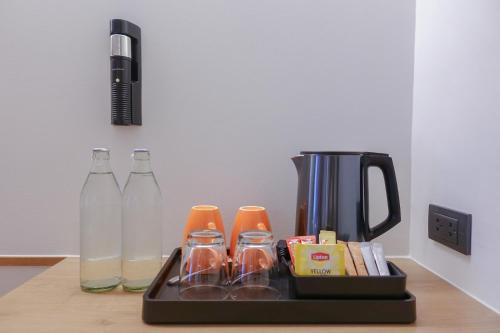 a tray with bottles of milk and a coffee maker at Lub d Bangkok Chinatown - Steps from Sam Yod MRT Station in Bangkok