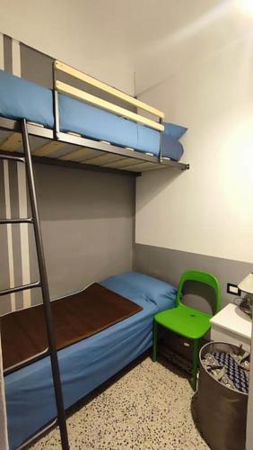 a bedroom with a bunk bed and a green chair at Vasto House in Vasto