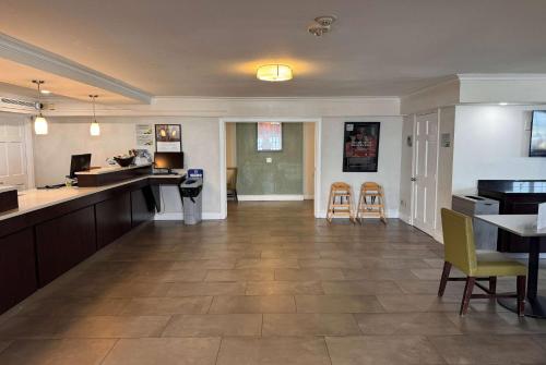 a large kitchen and dining room with tables and chairs at Wingate by Wyndham Galveston Beachfront at the Seawall in Galveston