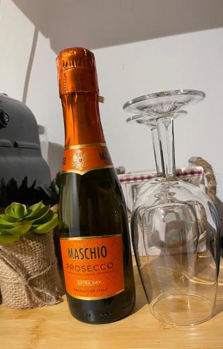 a bottle of wine sitting on a table next to a glass at Nido Ampezzano in Borca di Cadore
