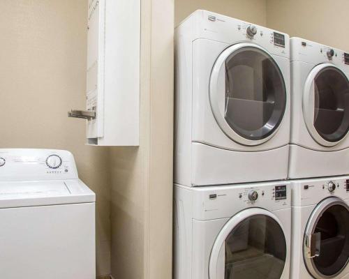 two washing machines and a washer and dryer in a room at MainStay Suites St Robert - Fort Leonard Wood in Saint Robert