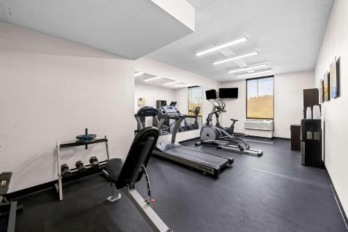 a gym with two treadmills and two exercise bikes at Comfort Inn & Suites Durham near Duke University in Durham