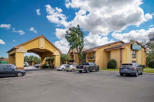 a hotel with cars parked in front of a parking lot at Quality Inn & Suites NRG Park - Medical Center in Houston