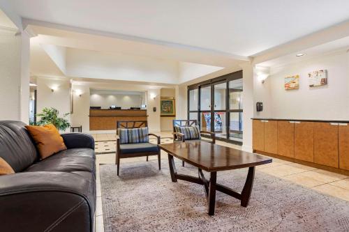 a living room with a couch and a coffee table at Quality Inn & Suites NRG Park - Medical Center in Houston