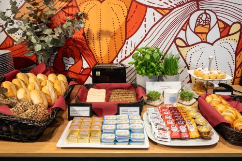 a table topped with lots of different types of food at Coffee Fellows Hotel Siegburg West in Siegburg