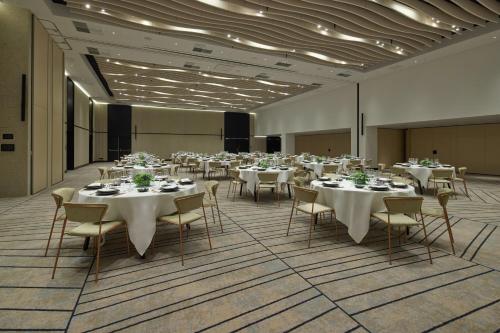 a banquet hall with white tables and chairs at Cardo Brussels, Autograph Collection in Brussels