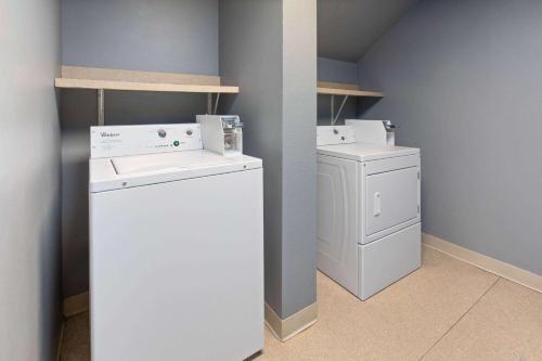 a laundry room with a washer and dryer at AmericInn by Wyndham North Branch in North Branch
