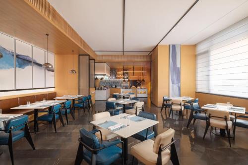 西安市にあるFairfield by Marriott Xi'an Yantaのテーブルと椅子のあるダイニングルーム