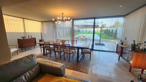 a living room with a dining table and a couch at Dream House 1 Valença in Valença