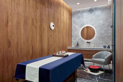 a room with a table with a chair and a sink at Hilton Bengaluru Embassy Manyata Business Park in Bengaluru