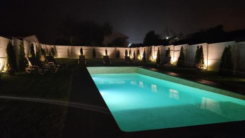 a swimming pool in the yard at night at Dream House 1 Valença in Valença