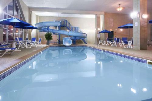 a swimming pool with a slide in a hotel at Country Inn & Suites by Radisson, Rapid City, SD in Rapid City