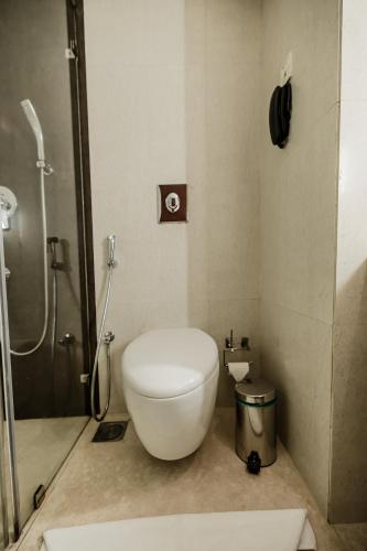 a bathroom with a toilet and a shower at Olive Downtown in Cochin