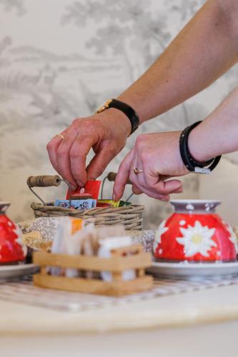 a person making a piece of food on a table at Casa Leon d'Oro in Bosco Chiesanuova