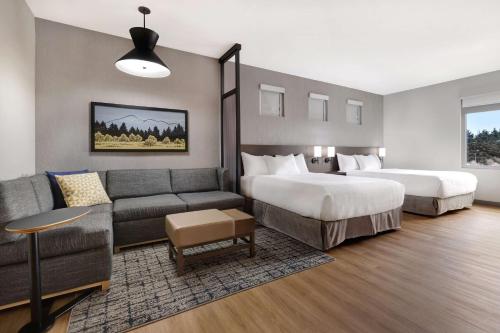 a hotel room with two beds and a couch at Hyatt Place Flagstaff in Flagstaff
