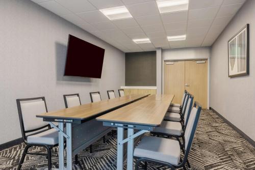 a conference room with a wooden table and chairs at Hyatt Place Flagstaff in Flagstaff