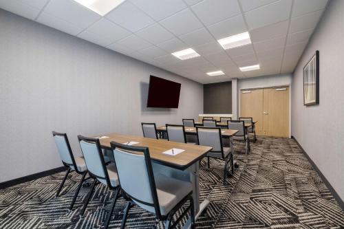 a conference room with tables and chairs and a screen at Hyatt Place Flagstaff in Flagstaff