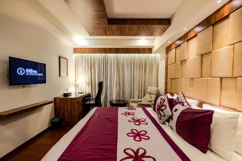 a hotel room with a bed and a television at Olive Downtown in Cochin