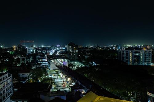 a view of a city at night with a bridge at Olive Downtown in Cochin