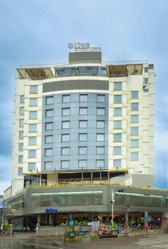 a large white building with a sign on top of it at Olive Downtown in Cochin