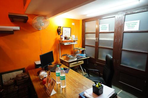 an office with a wooden desk with a computer on it at Haveli Kalwara - A Heritage Hotel in Jaipur