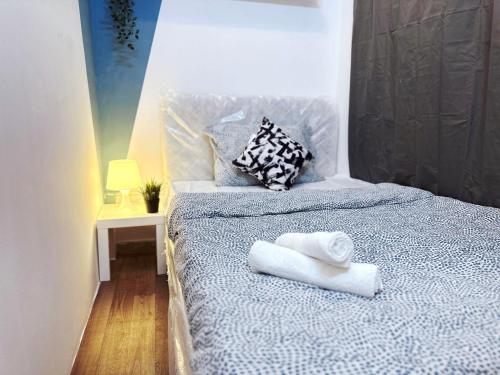 a bedroom with a bed with towels on it at Inspire Partition Room in Al Seef Near Burjuman Metro in Dubai