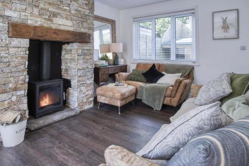 a living room with a couch and a fireplace at Taf Fechan - 3 Bedroom House - Pontsticill in Merthyr Tydfil