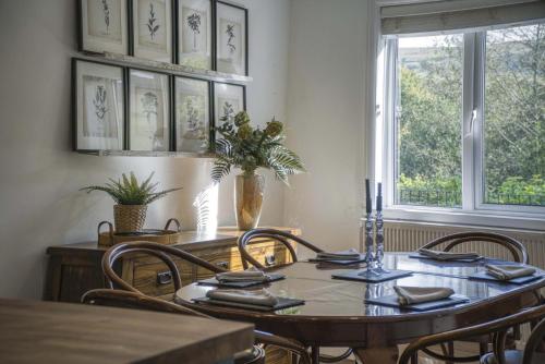 a dining room with a table and chairs and a window at Taf Fechan - 3 Bedroom House - Pontsticill in Merthyr Tydfil